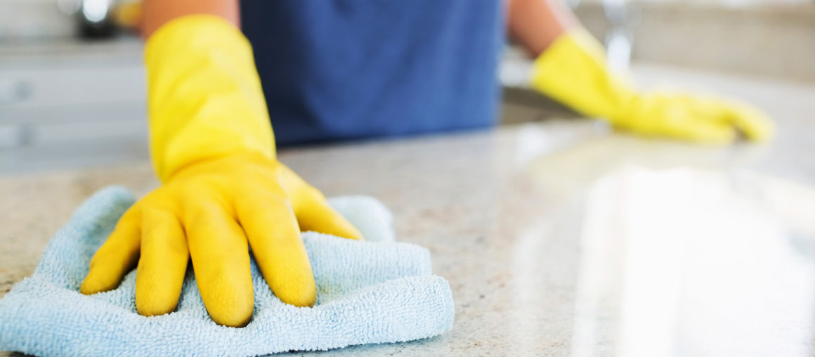Woman cleaning the counter  in the kitchen