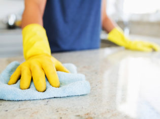 Woman cleaning the counter  in the kitchen