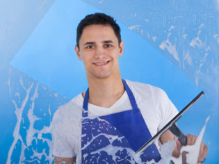 Male Servant Cleaning Glass With Squeegee