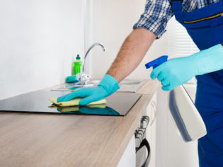 Worker Cleaning Electric Hob